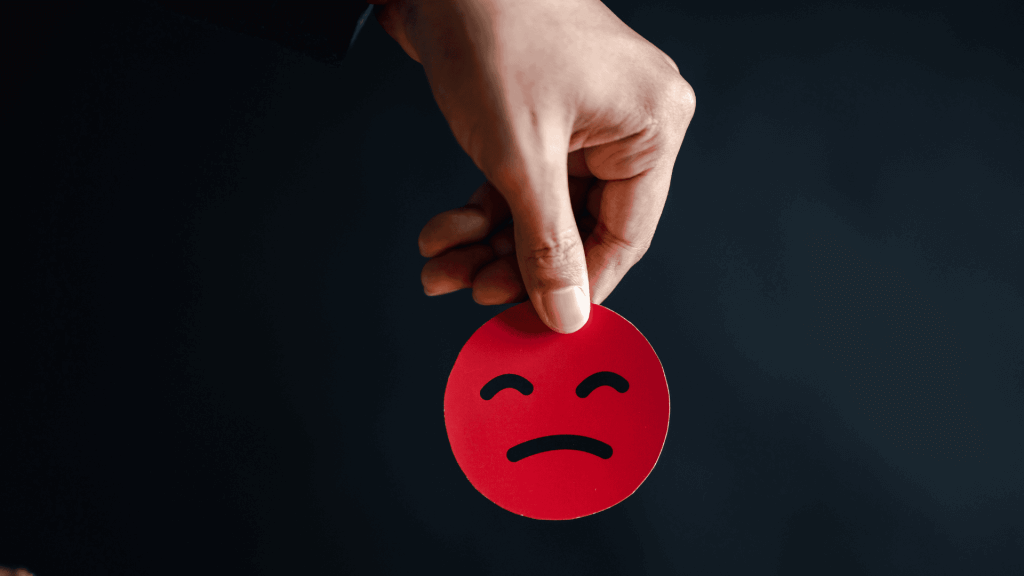 Emoticône rouge qui représente les inconvénients du bilan de compétences